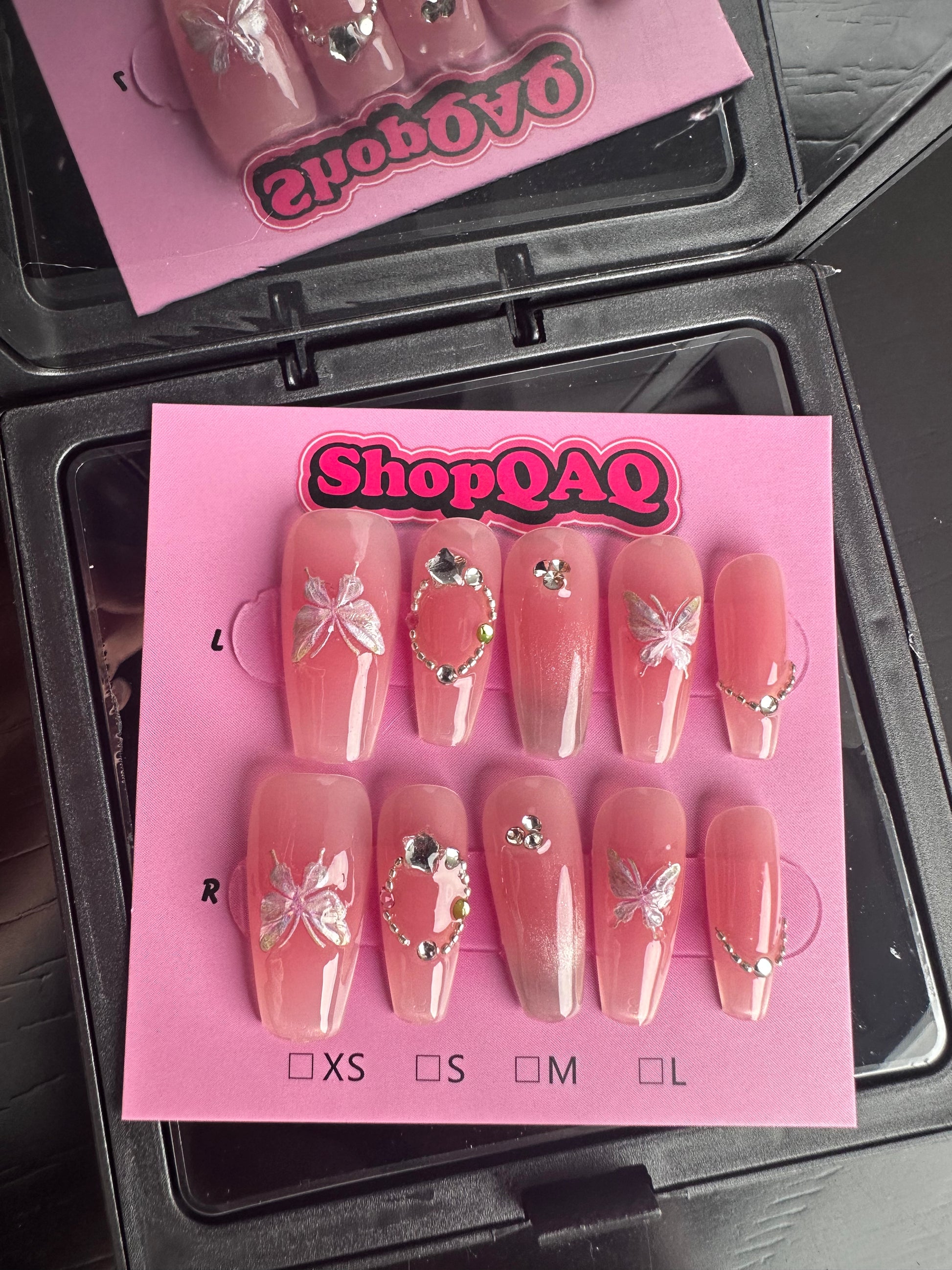 Here's a product description for your nail design:  "2024 New Year Crystal Butterfly Nails | Sweetheart Girl, Gentle & Clear, White-Enhancing Handcrafted Press-On Nails with Cat Eye and Blush Accents" False Nails from SHOPQAQ